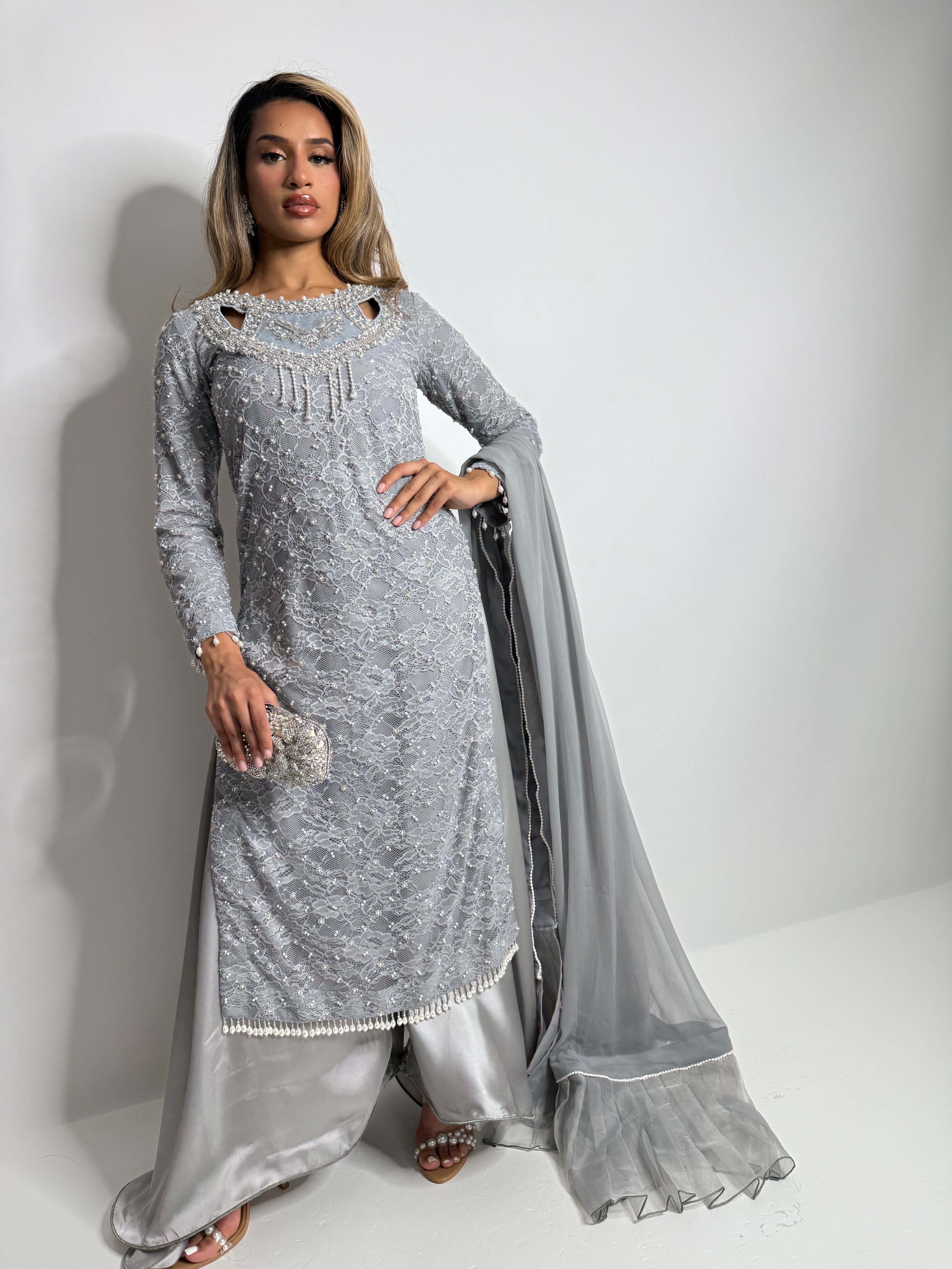Full-length front view of silver Pakistani outfit with dupatta.