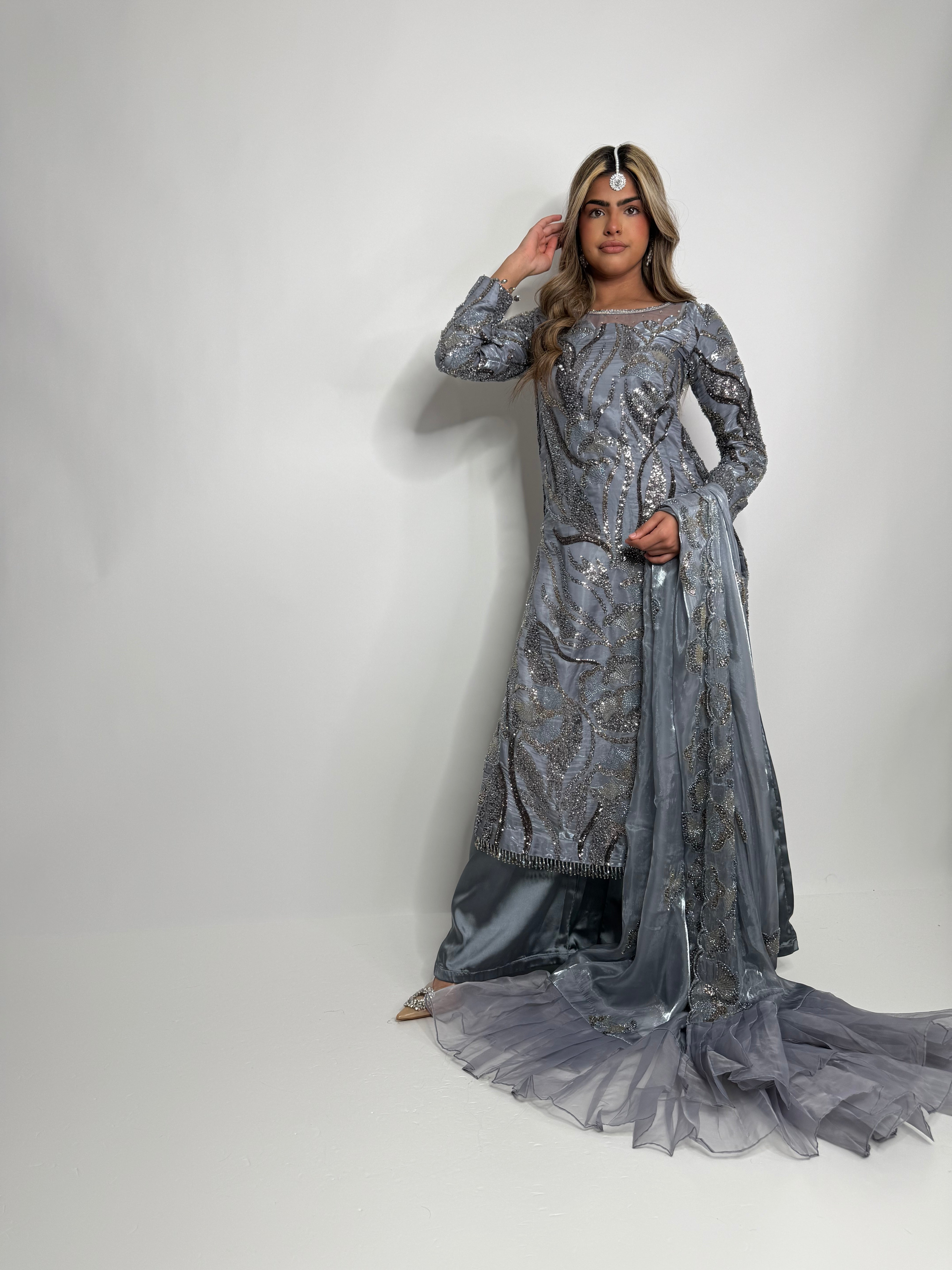 Model wearing Selara Silver Grey Embroidered Silk Pakistani Suit with silk dupatta.