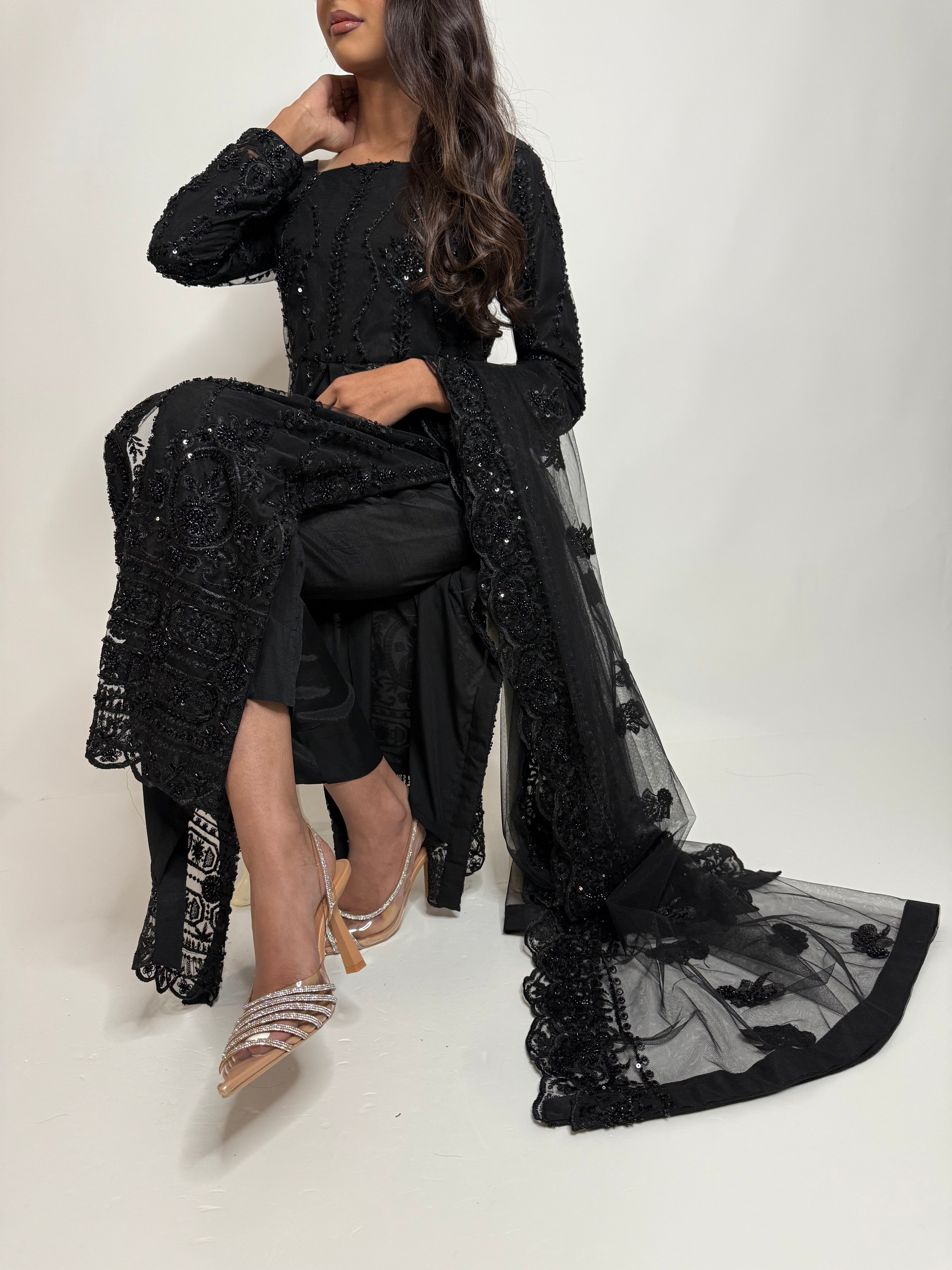 Full black desi outfit for daawats and receptions – model seated wearing Ameliyana