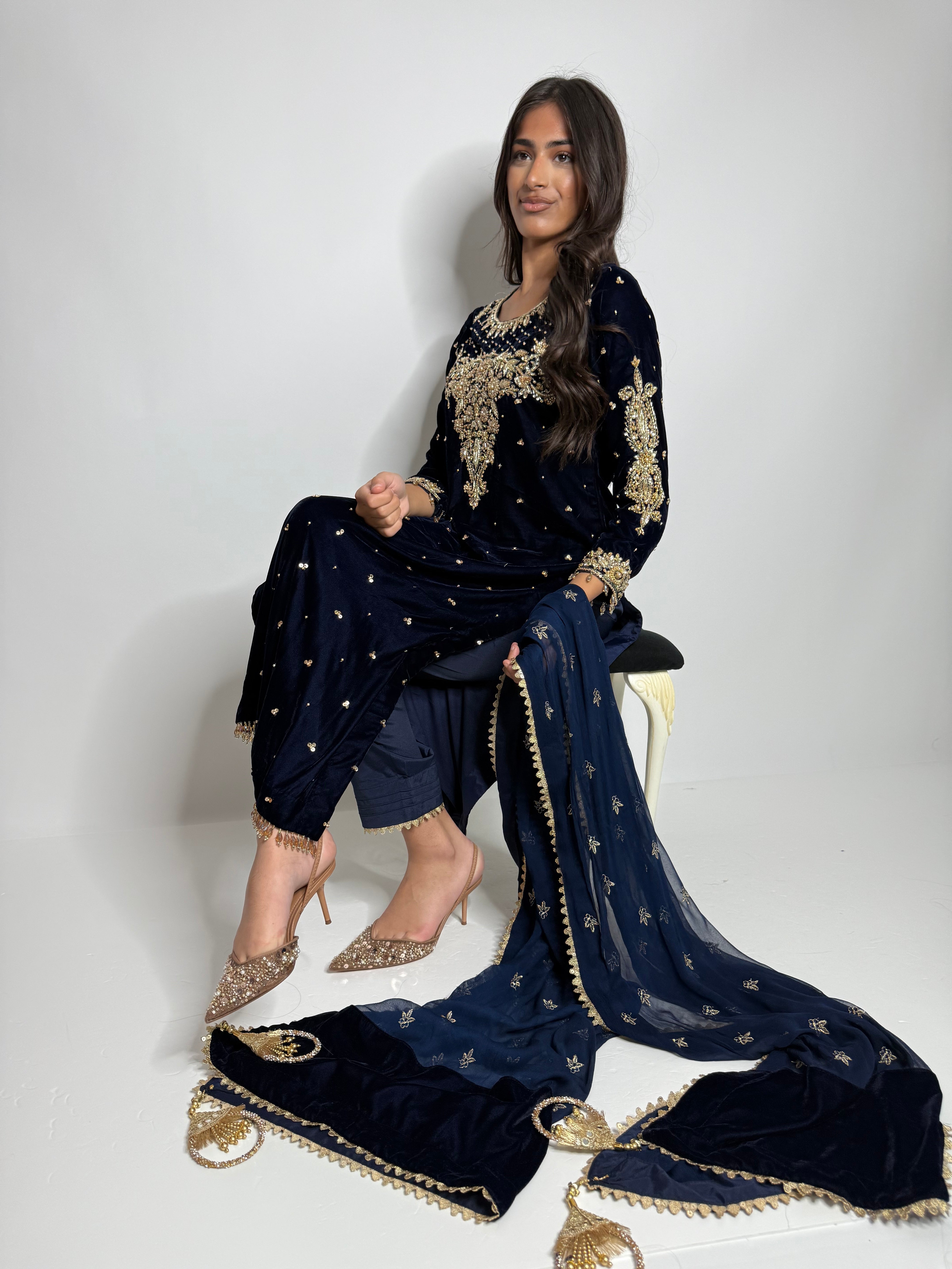 Outfit details showing a velvet Pakistani wedding guest outfit, raw silk trousers, and tassel-finished dupatta.