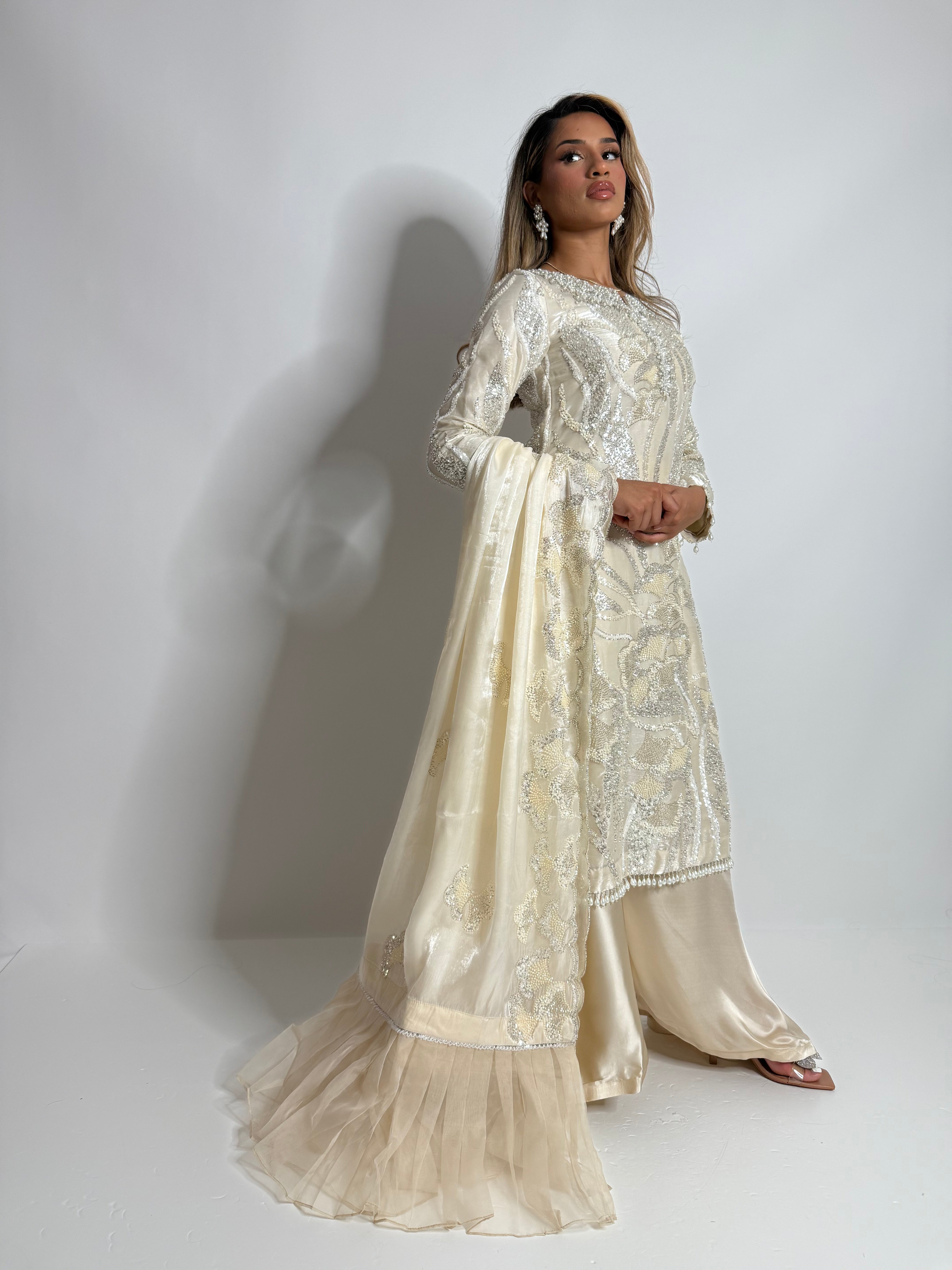 Ameliyana Boutique Elyra Ivory Embellished Three-Piece with pearl handworked neckline, silk trousers, and embroidered dupatta with organza frill”