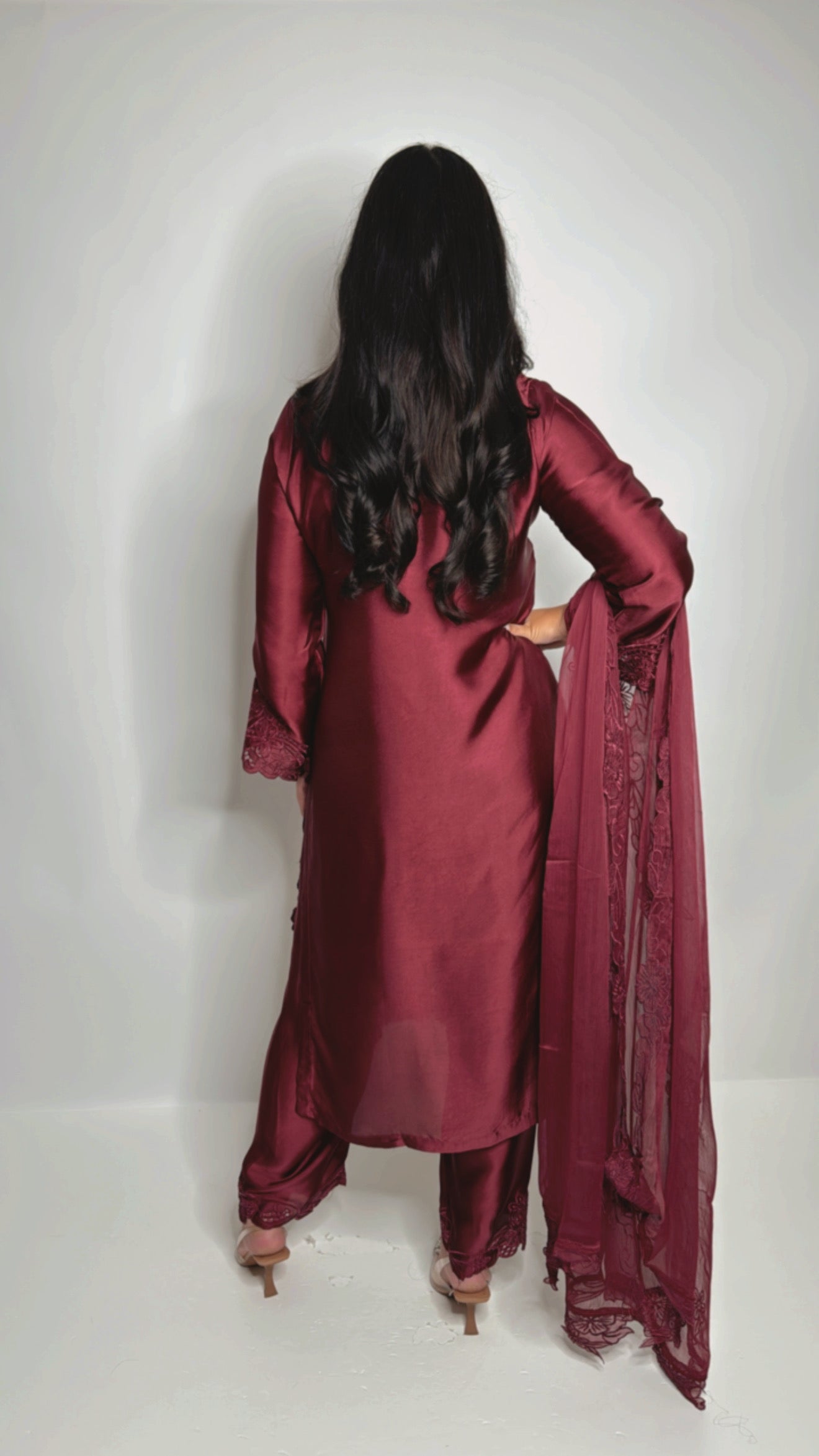 Back view of wine embroidered three-piece suit with dupatta drape