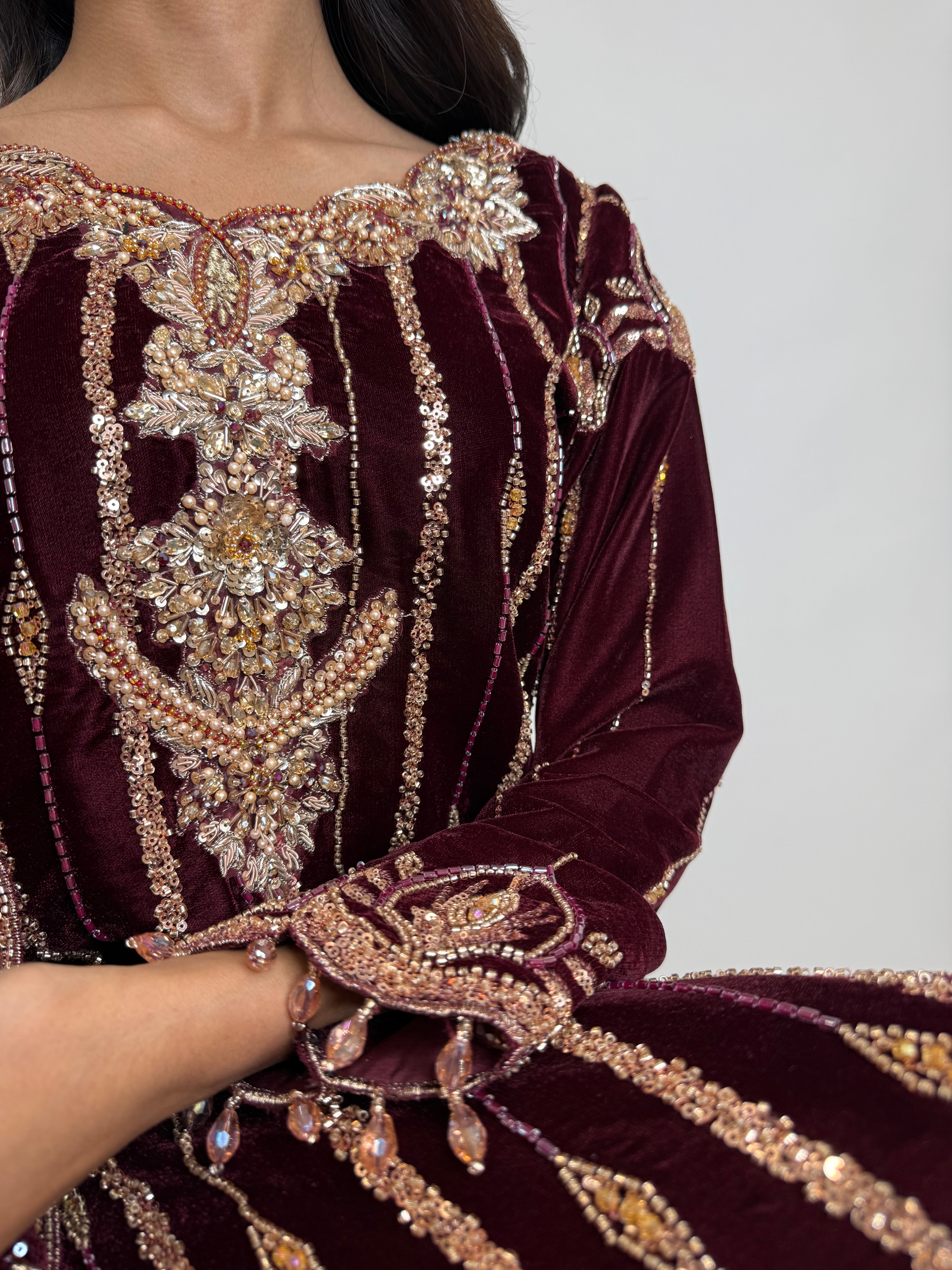Close up cutdana embroidery on wine velvet Pakistani suit