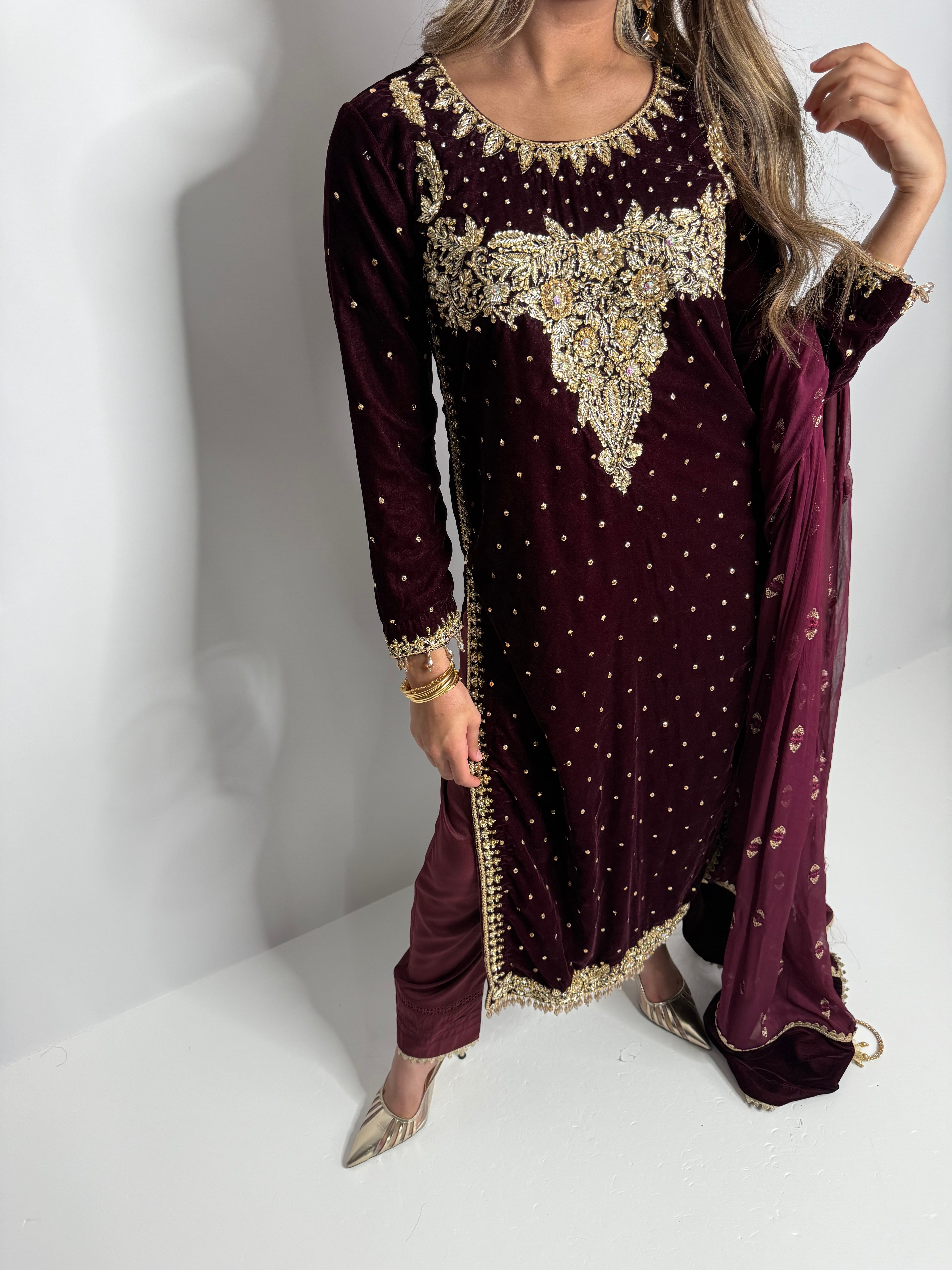 Outfit details showing velvet fabric, raw silk trousers, and tassel-finished dupatta.