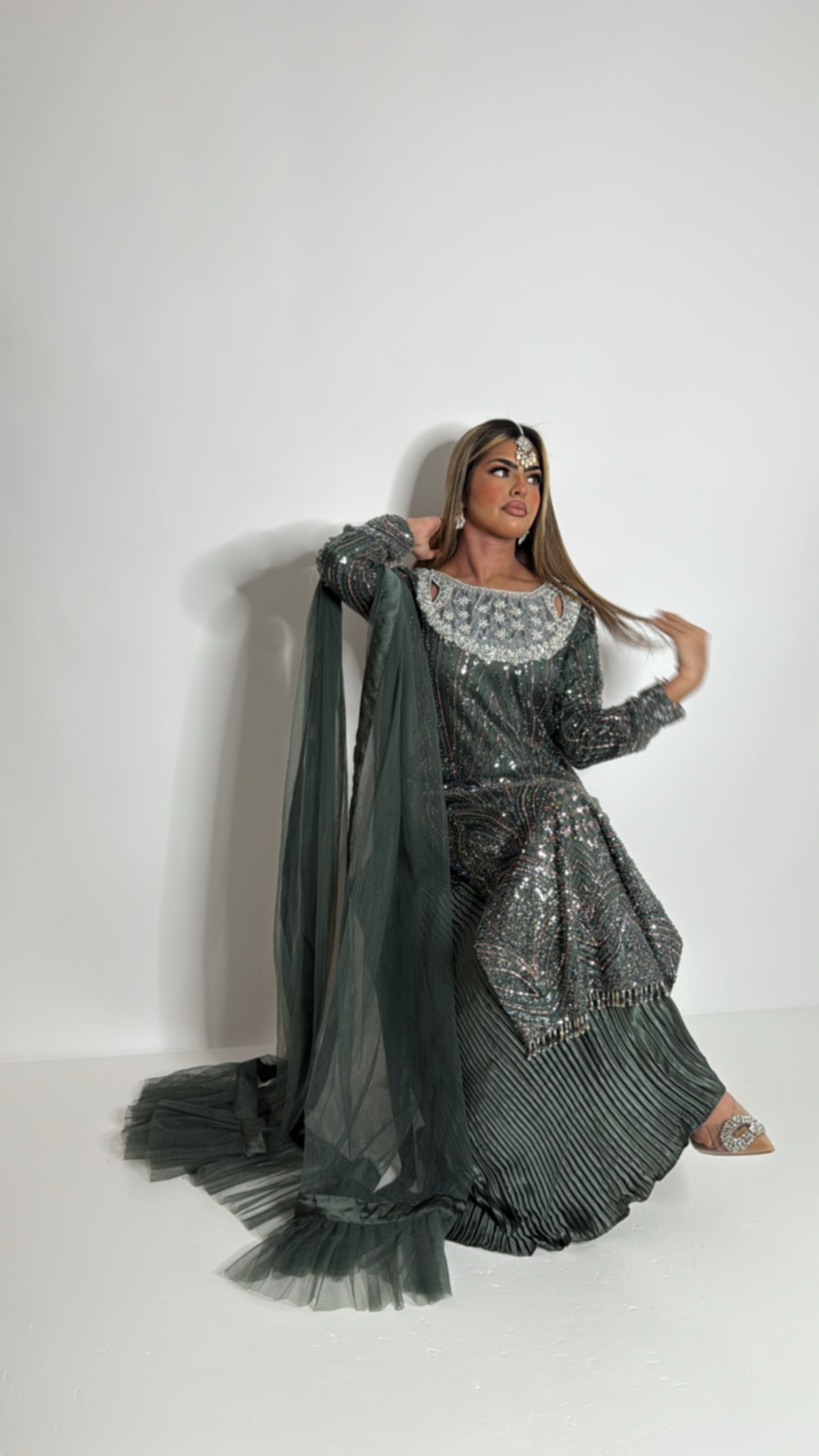 Emerald green cutdana embroidered Pakistani suit with pearl-detailed neckline, crushed silk trousers, and net frill dupatta.