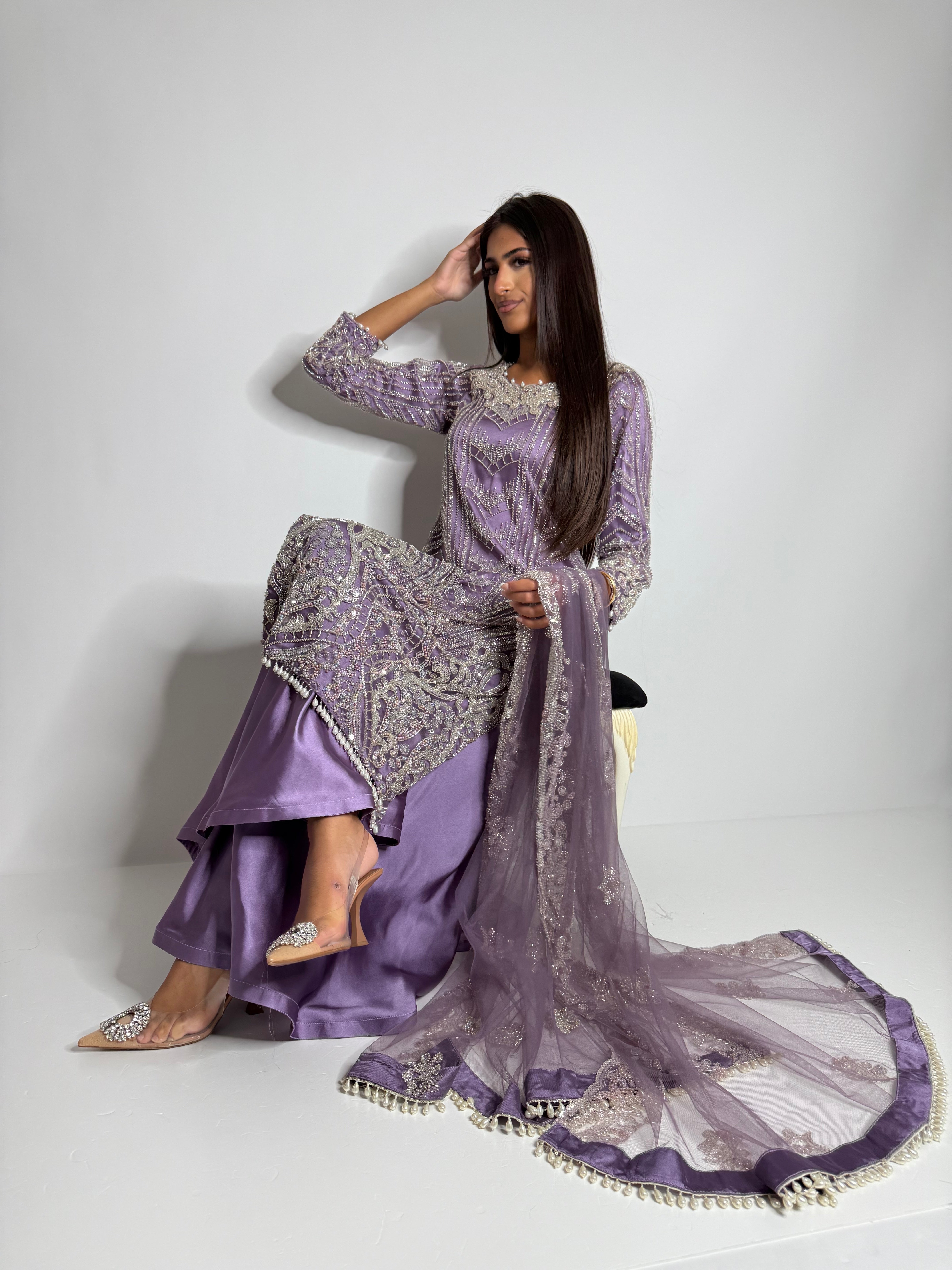Model showcasing dusky lavender wide-leg trousers and embellished shirt