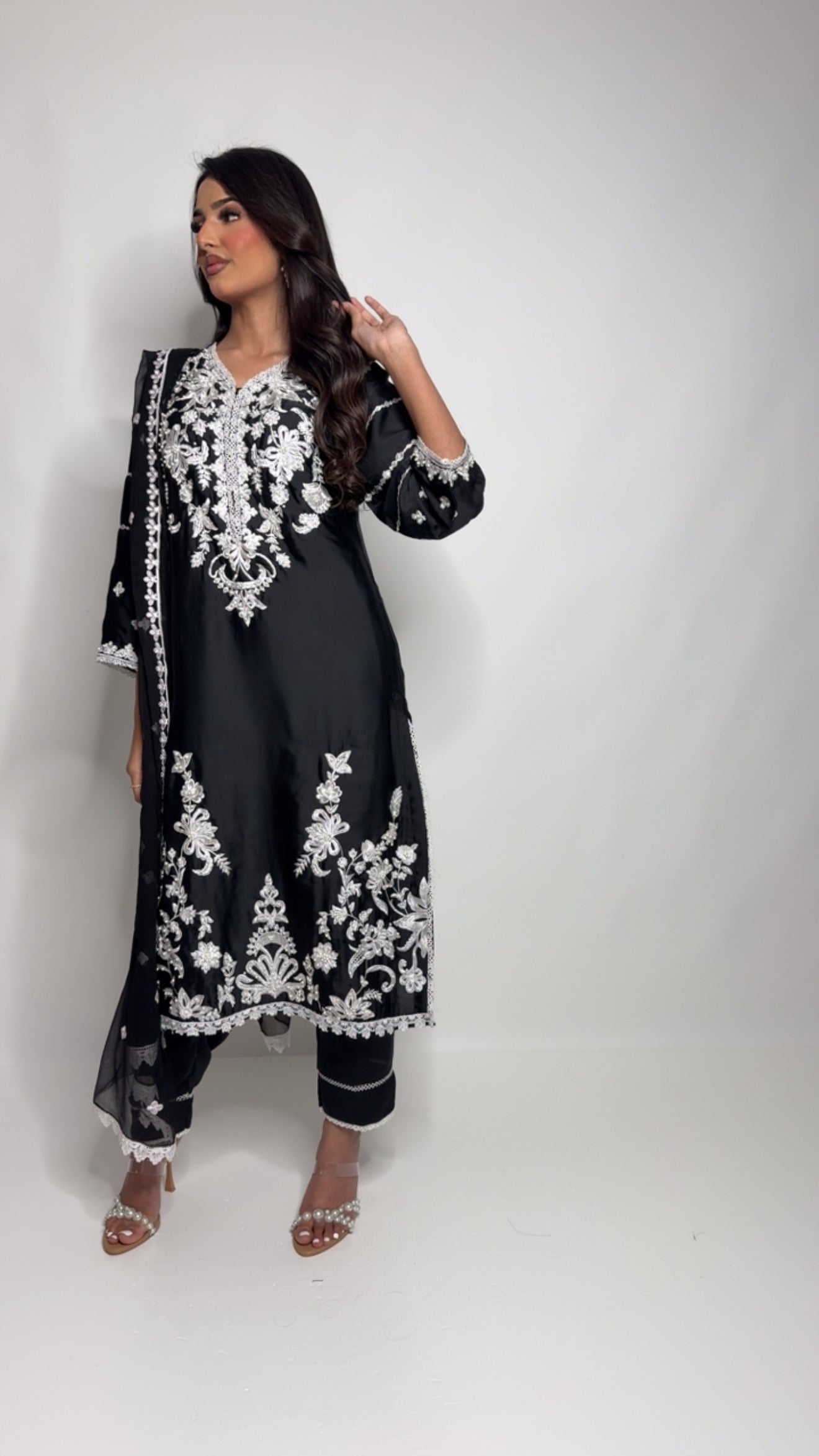 Black silk three-piece Pakistani outfit with white thread embroidery – includes shirt, trousers, and dupatta