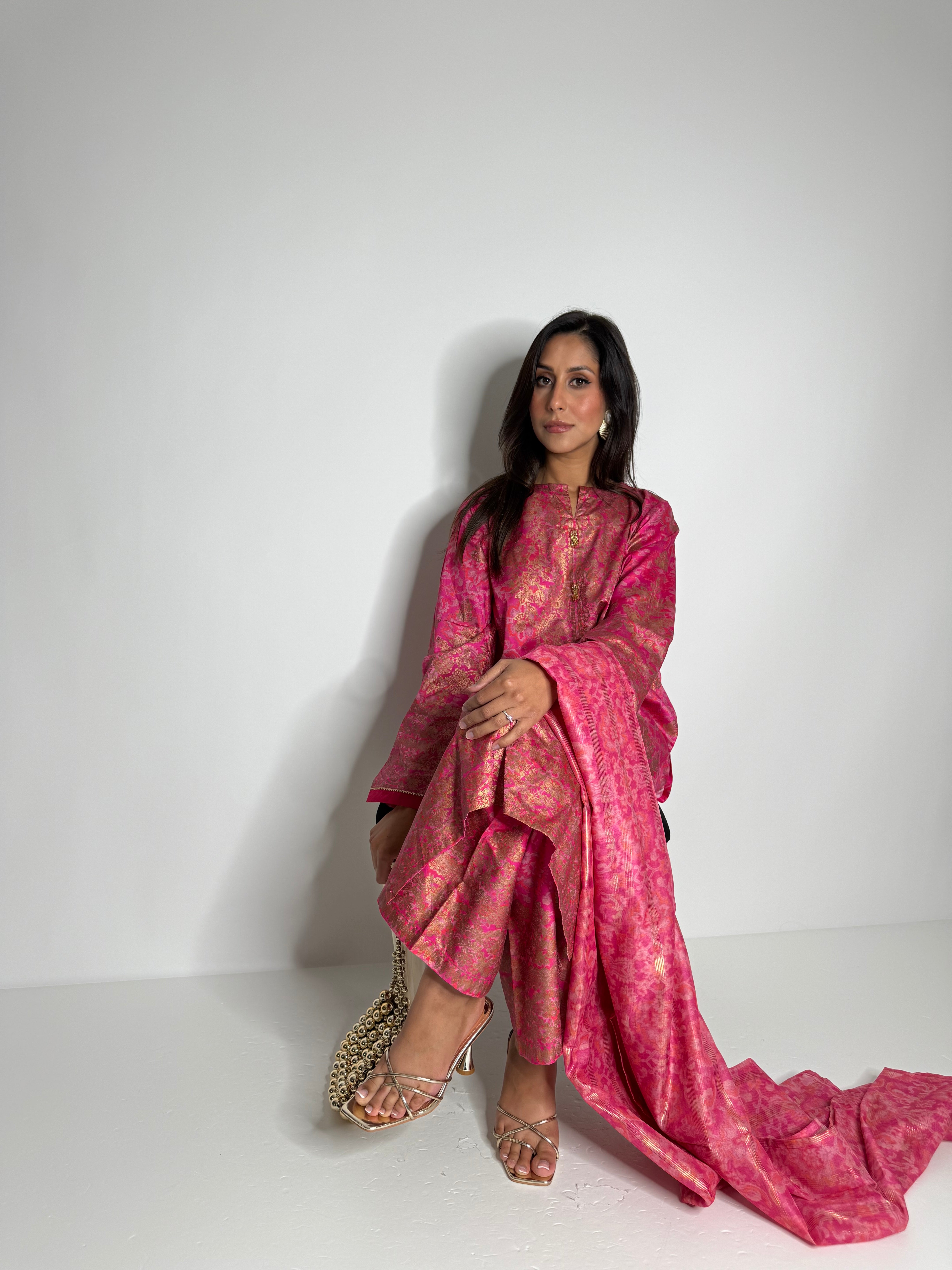 Full-length view of Limelight fuchsia silk outfit with woven detailing.