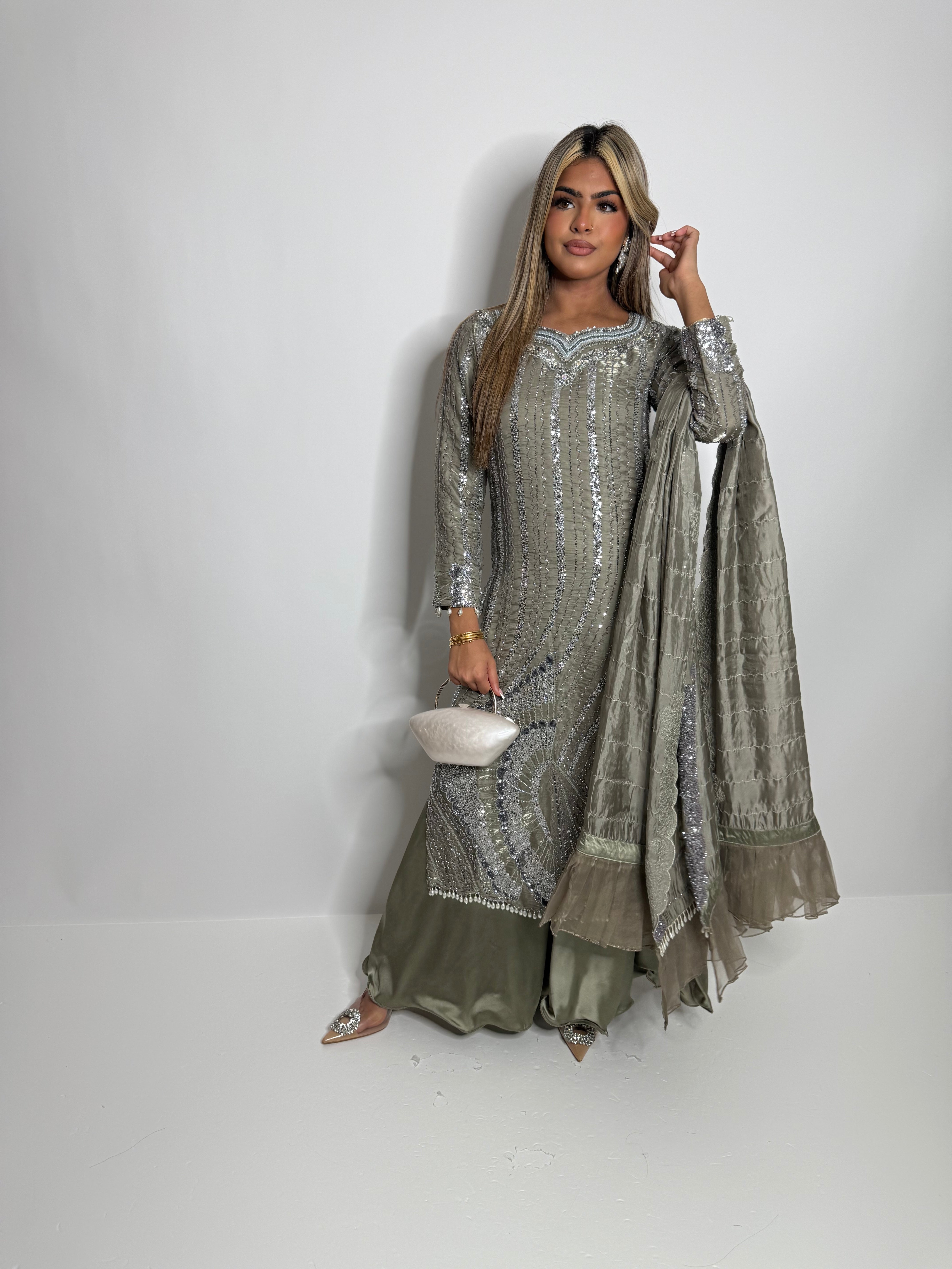 Model in smoky sage wide-leg trousers and embellished silver shirt