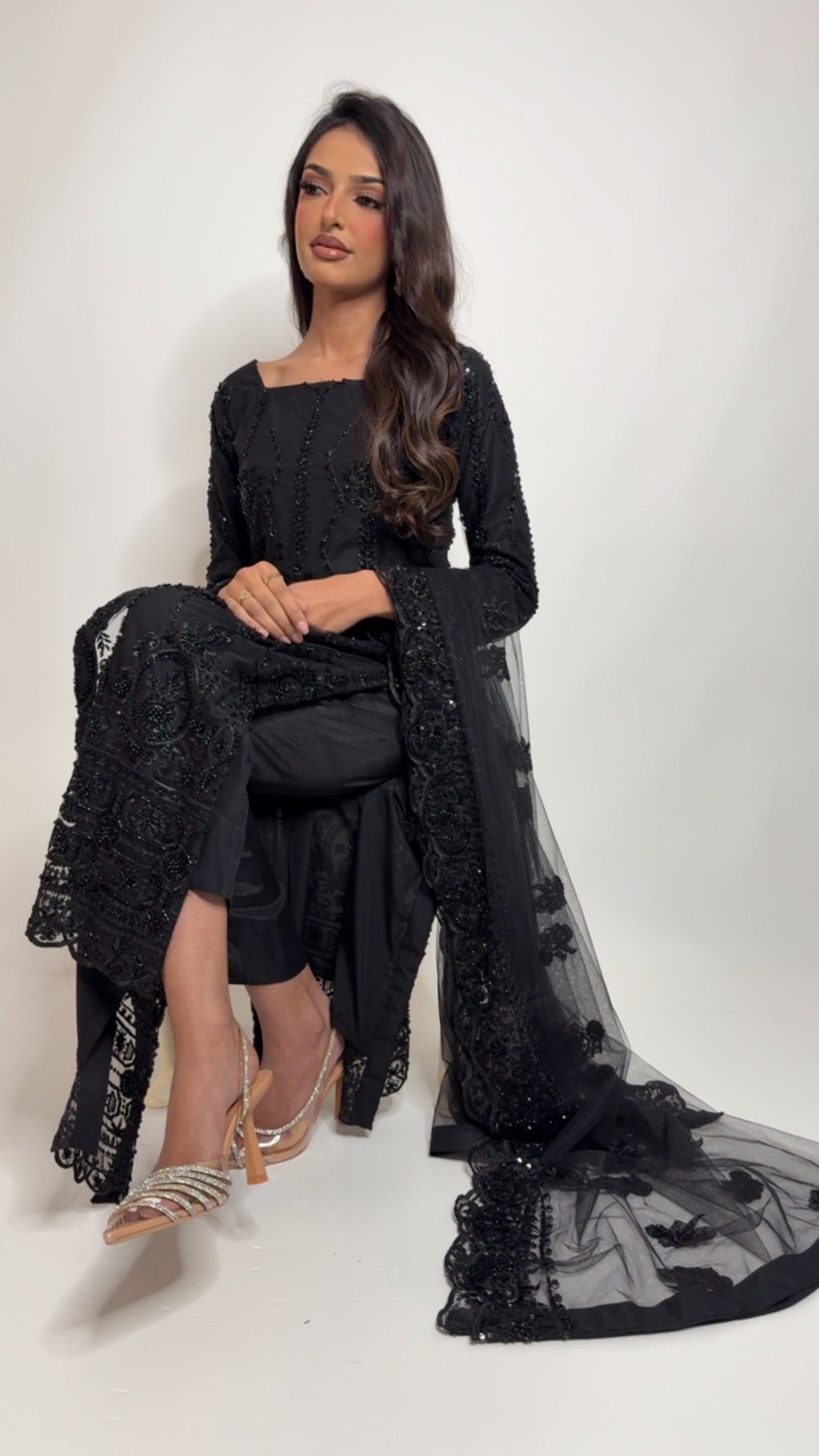 Full black desi outfit for daawats and receptions – model seated wearing Ameliyana