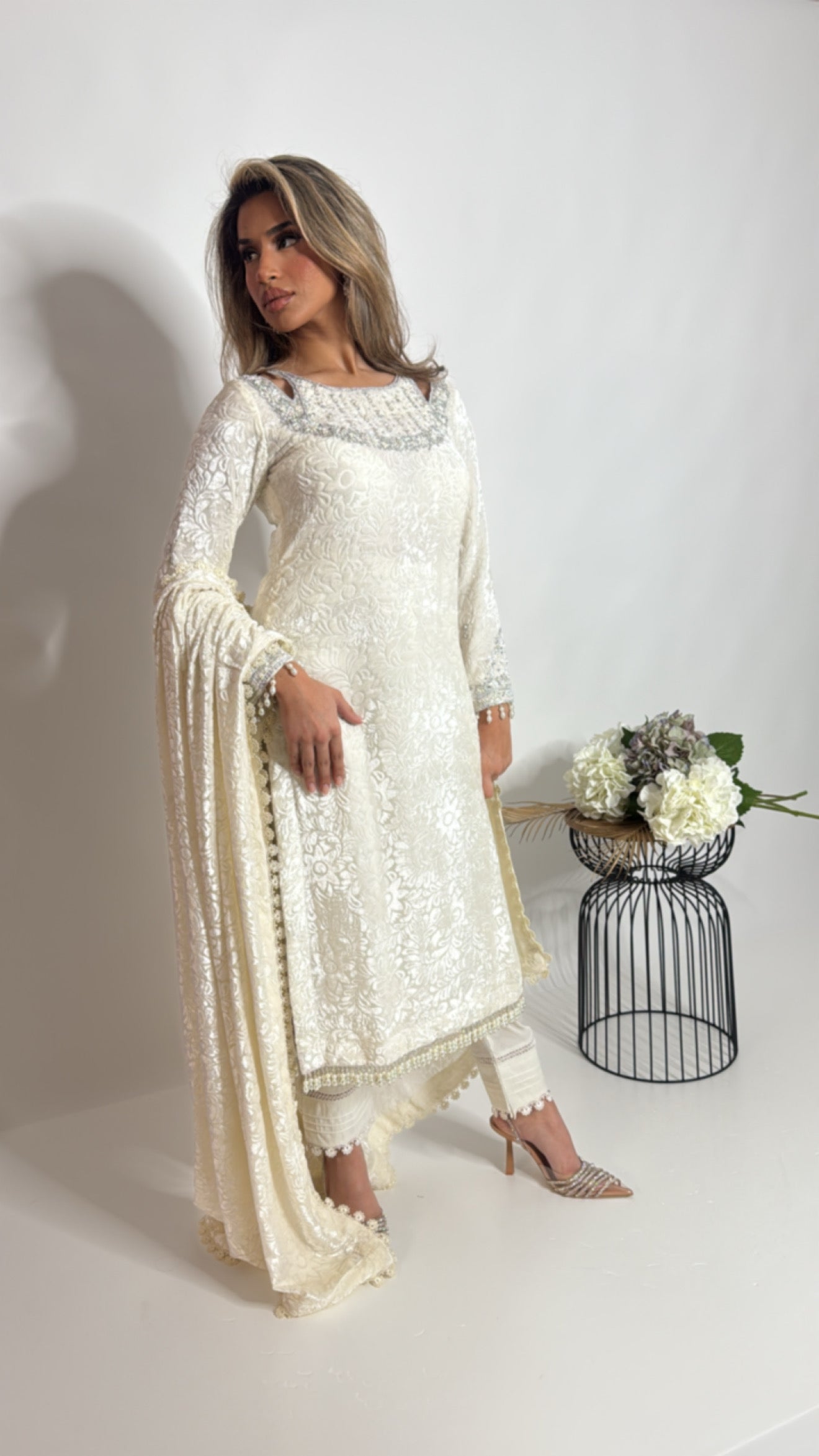 Close-up of embroidered neckline and pearl handwork on ivory palachi shirt