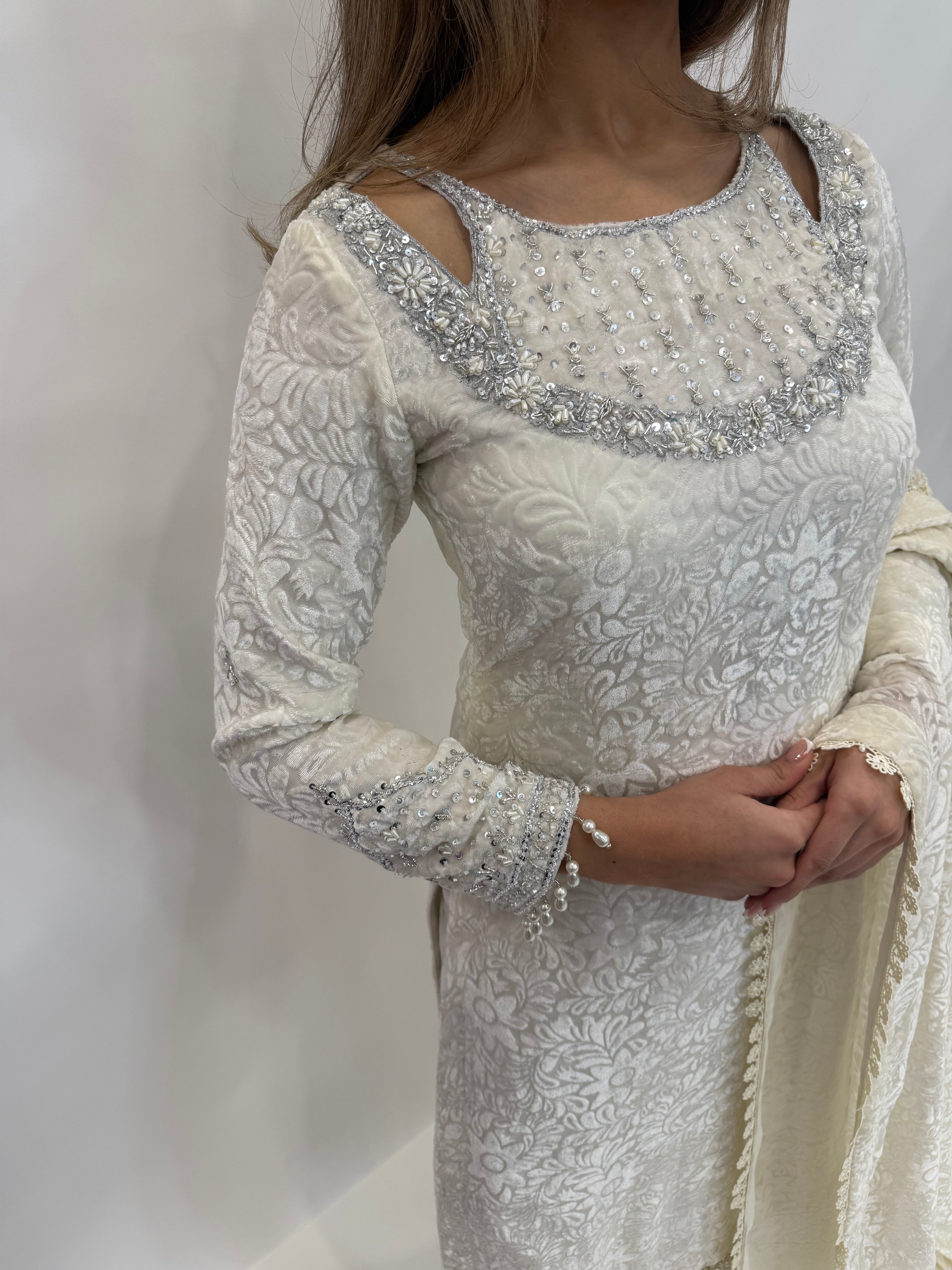 Close-up of embroidered neckline and pearl handwork on ivory palachi shirt