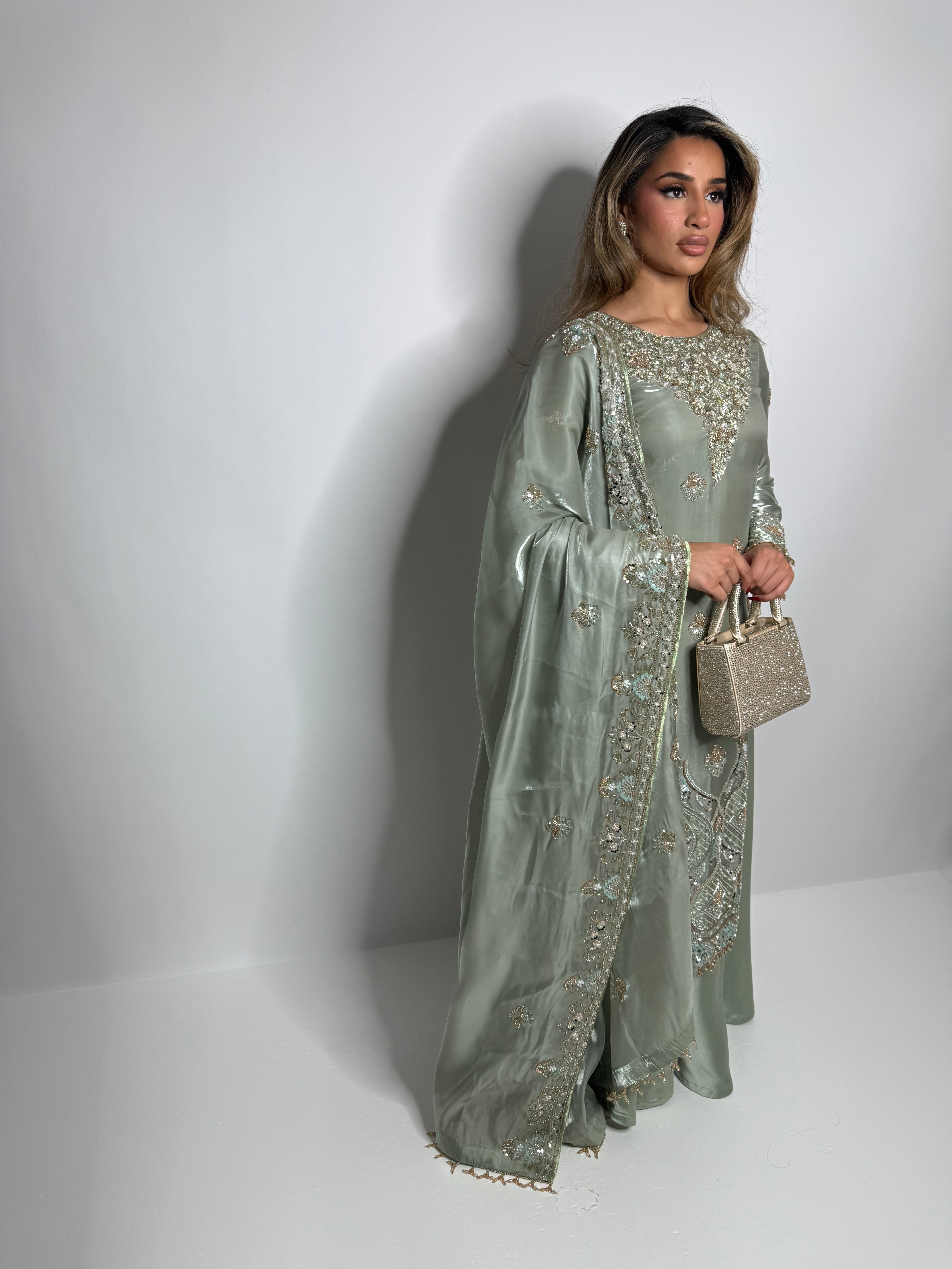 Luxury wedding guest outfit in sage green with hand embroidery