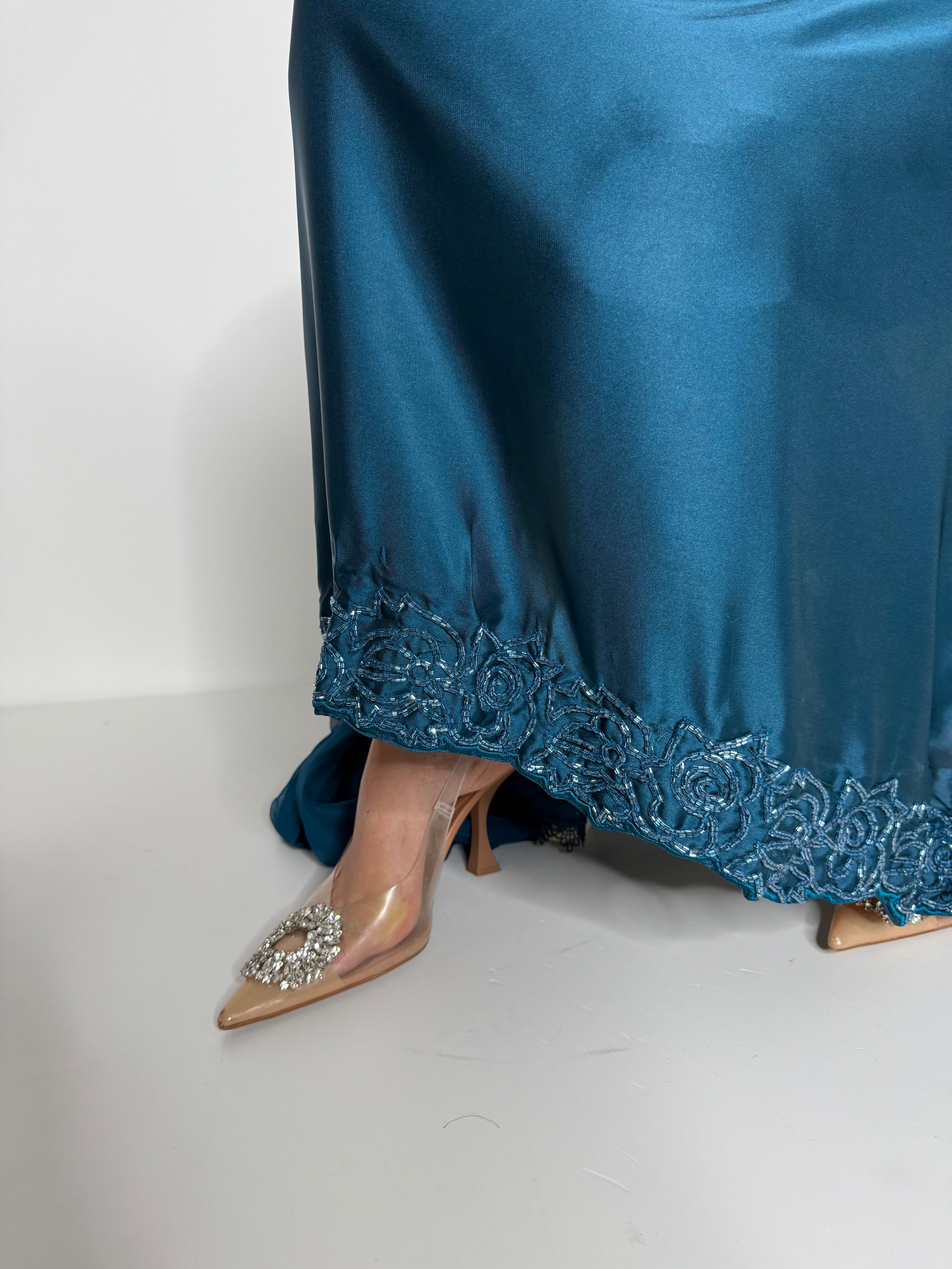 Close-up of embroidered neckline on teal blue silk Eid outfit