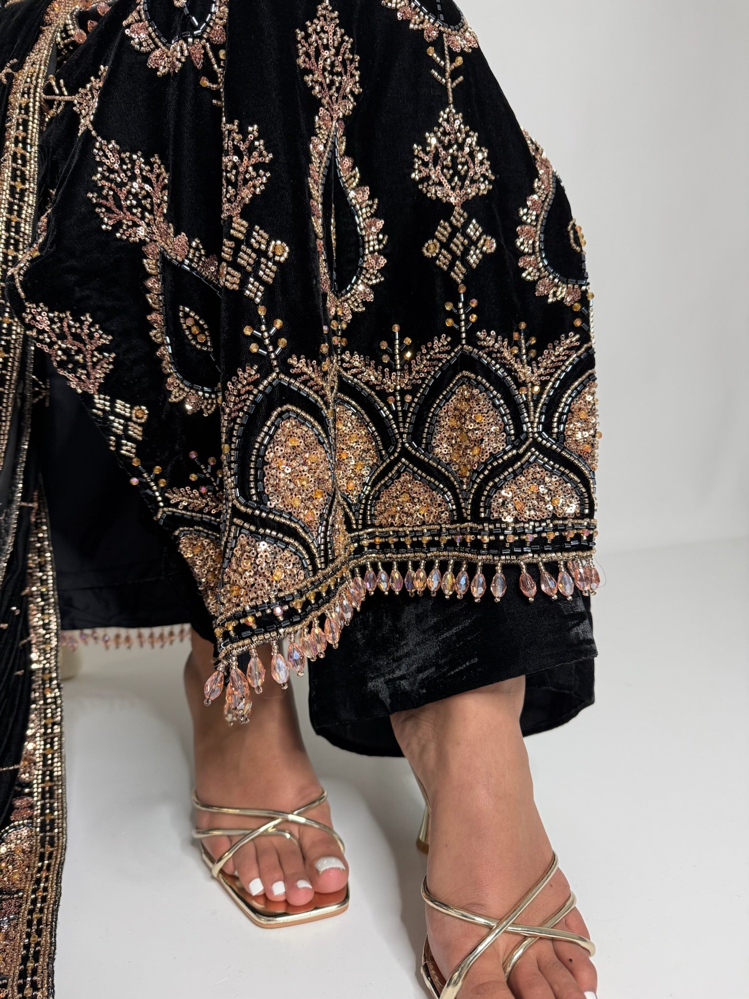 Close up of gold cutdana work on black velvet