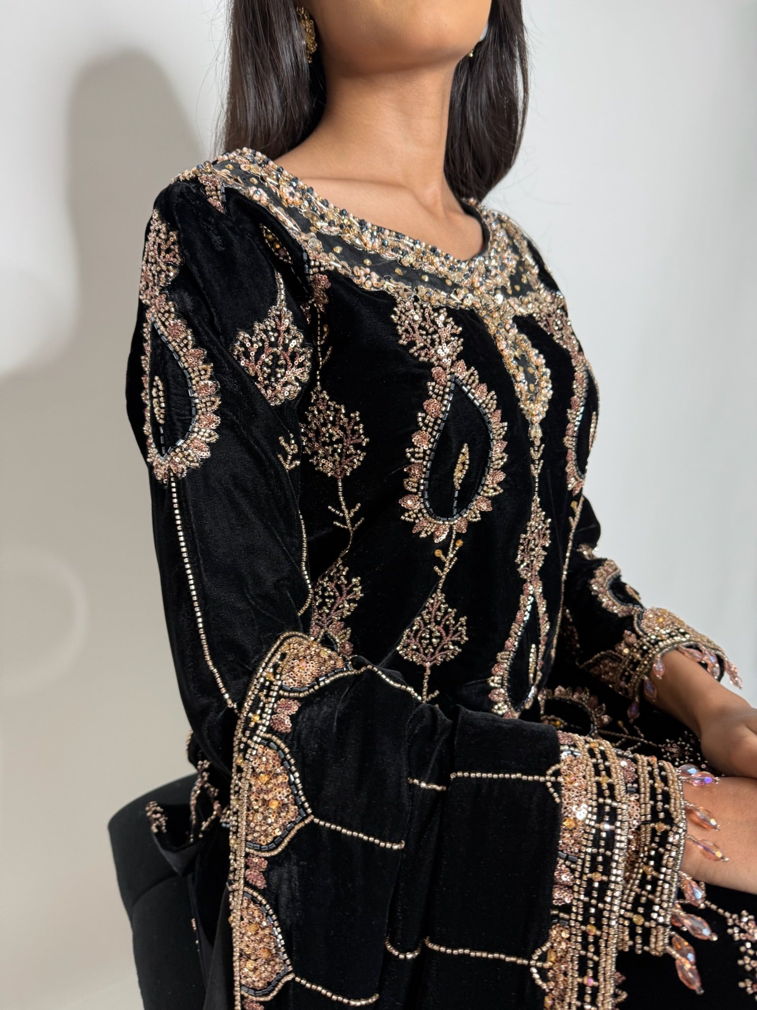 Detailed neckline embroidery on black velvet Pakistani suit