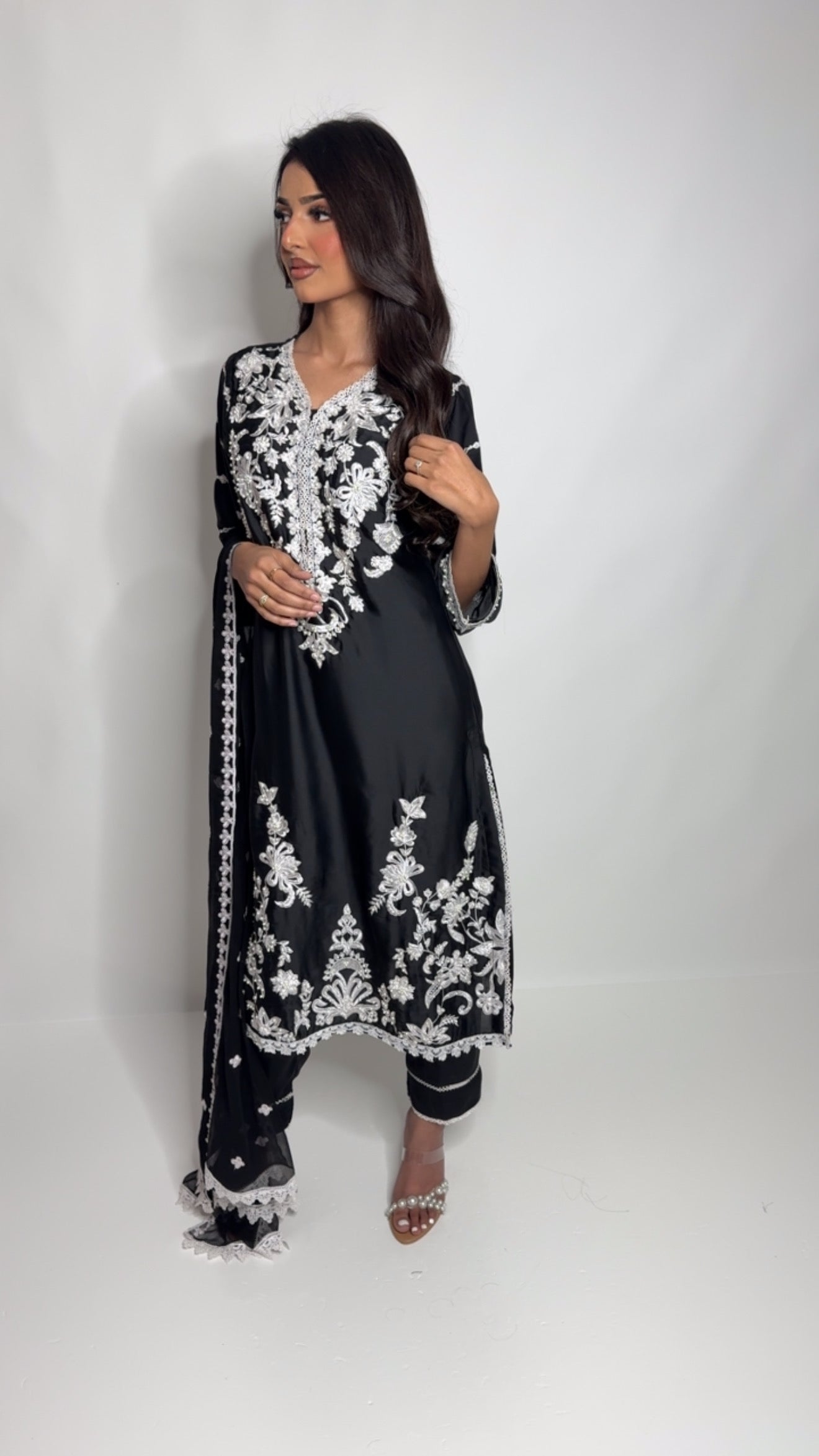 Black silk three-piece Pakistani outfit with white thread embroidery – includes shirt, trousers, and dupatta